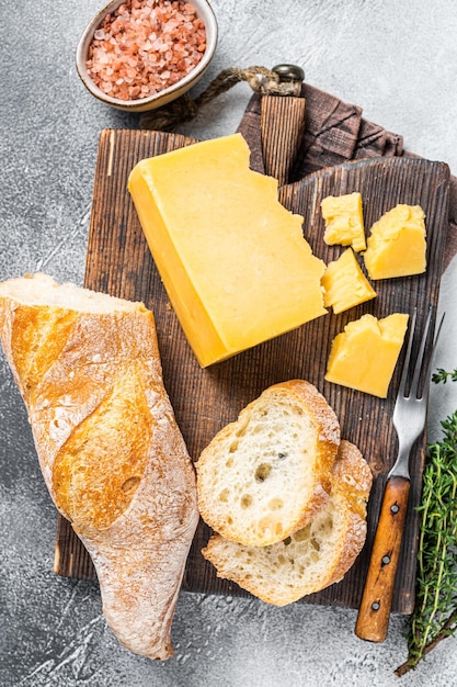 Gouda cheese with bread ready for cooking sandwich. White background. Top view.