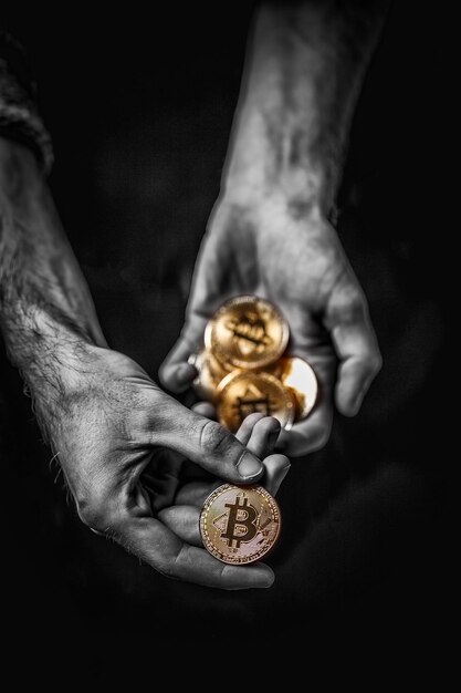 Gouden Bitcoin in de hand van een man