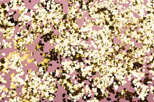 Gouden confetti glitter op roze achtergrond Feestelijke vakantie pastel achtergrond Greeteng kaarten sjabloon