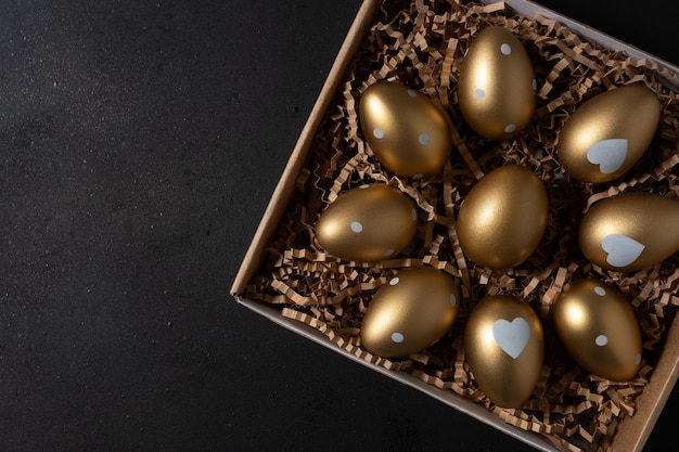 Gouden eieren in een papieren doos op een tafel