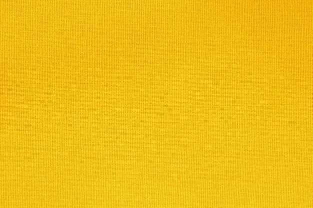 Gouden gele katoenen stof textuur achtergrond met naadloze patroon.