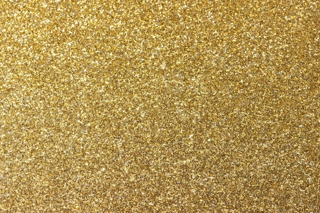 Foto gouden glanzende achtergrond. new year's heldere geel-gouden abstracte achtergrond voor design