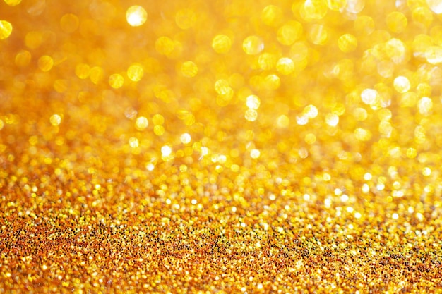 Gouden glitter schittering met bokeh achtergrond