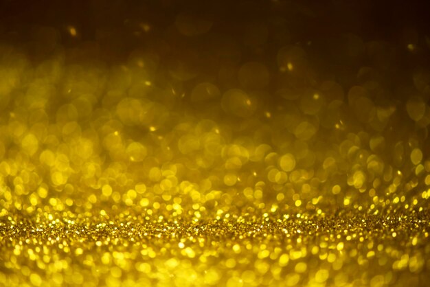 Gouden glitter sprankelende lichten achtergrond Defocused glitter abstracte twinkelend licht en glanzende sterren Kerstmis en Nieuwjaar feest concept achtergrond Closeup sterrenstof