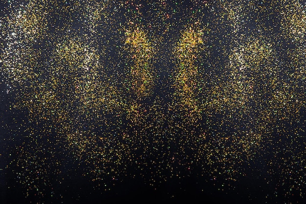Gouden glitter vakantie textuur op een zwarte achtergrond Gouden explosie van confetti Gouden korrelige abstracte textuur op een zwarte achtergrond Nachtelijke hemel stijl achtergrond