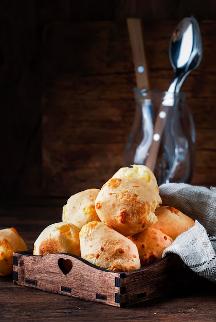 Gouden kaasbroodjes in houten dienblad rustieke keukentafel kopieerruimte