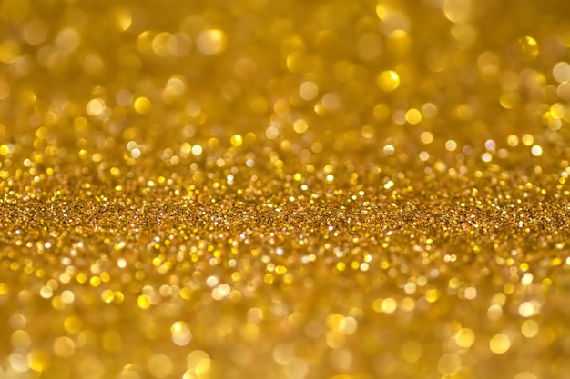 Gouden pailletten schijnen helder Geel poeder Glitter- en bokehlichten