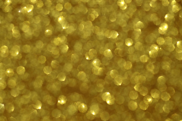 Gouden schittering onscherpe achtergrond met glitter en vervaging textuur