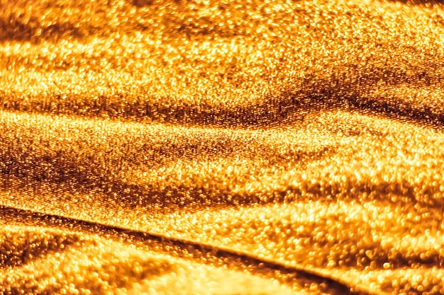 Gouden vakantie sprankelende glitter abstracte achtergrond luxe glanzende stof materiaal voor glamour design en feestelijke uitnodiging