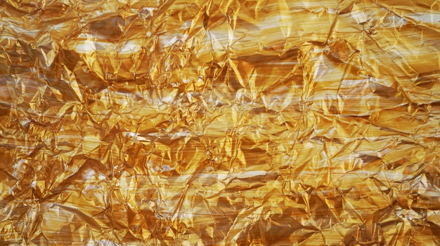 Gouden verfrommeld folie textuur achtergrond
