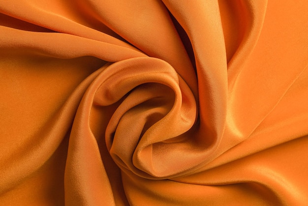 Gouden zijde of satijn luxe stof textuur kan als abstracte achtergrond gebruiken