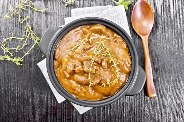 Goulash of beef in pan on black board top