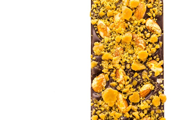 Gourmet almond toffee chocolate bar on a white background.