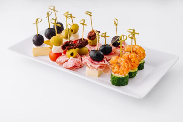 Photo gourmet appetizer selection on a white platter against a clean backdrop