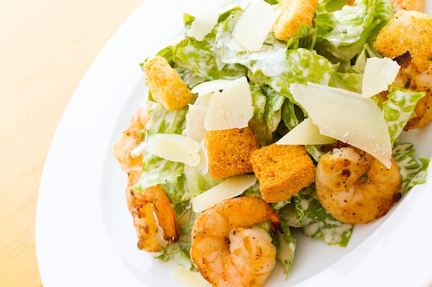 Gourmet caesar salad with grilled shrimp and croutons.