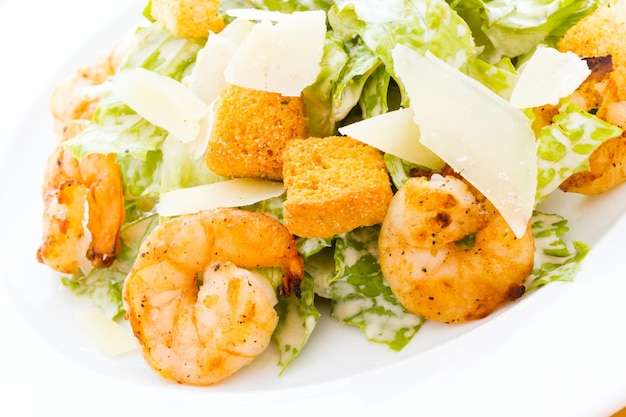 Gourmet caesar salad with grilled shrimp and croutons.