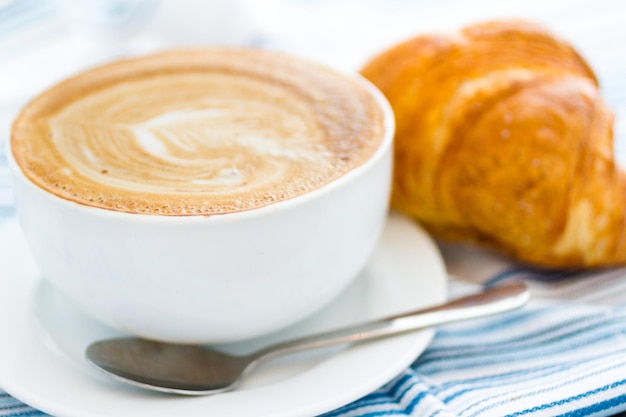 Gourmet caffe latte with leaf design in foam.