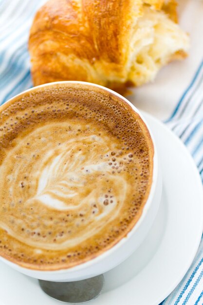 Gourmet caffe latte with leaf design in foam.