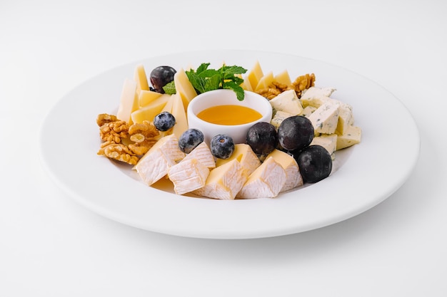 Gourmet cheese platter with honey and fruits