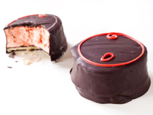 Gourmet chocolate covered blood orange marshmallows on white background.