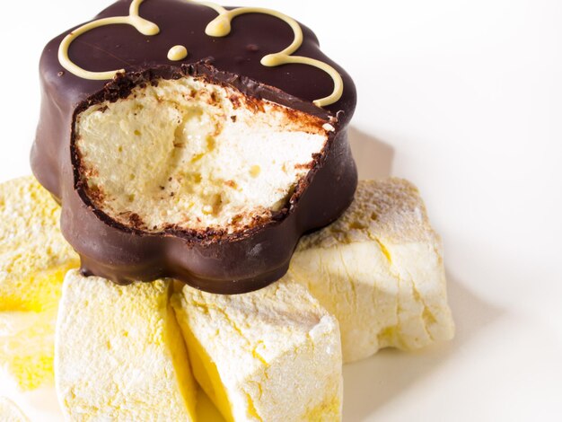 Gourmet chocolate covered passion fruit marshmallows on white background.