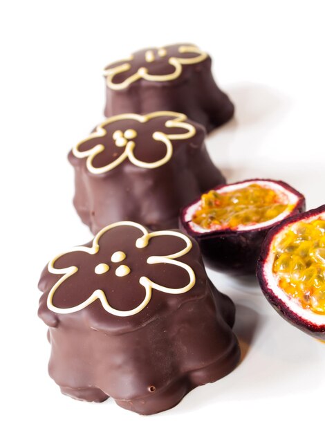 Gourmet chocolate covered passion fruit marshmallows on white background.