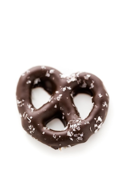 Gourmet chocolate covered pretzel with sea salt on a white background.