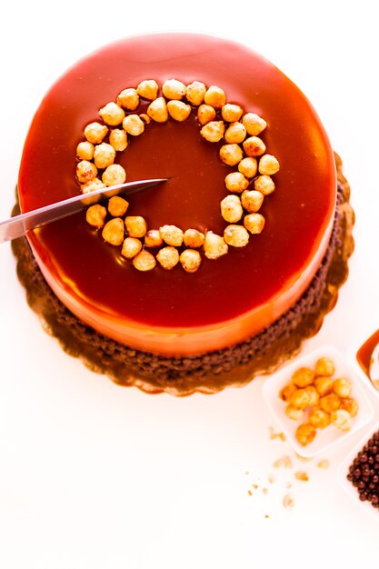 GOurmet chocolate, hazelnut, and caramel cake on white background.