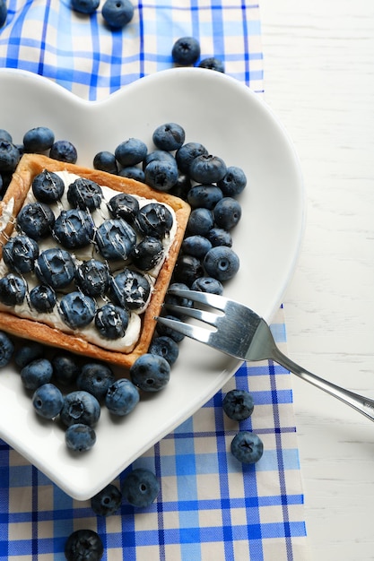 Gourmet fresh blueberry tart on plate close up