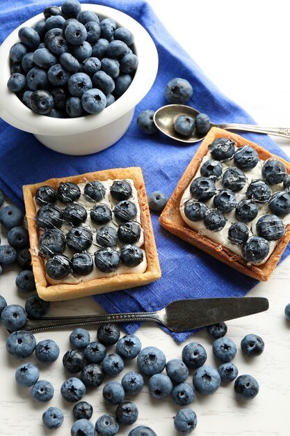 Gourmet fresh blueberry tarts on table