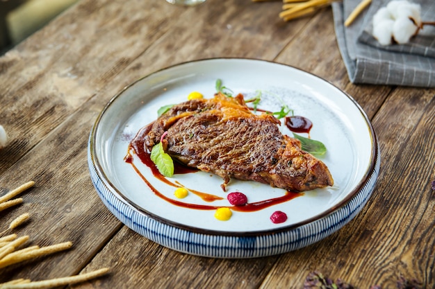 Gourmet grilled mutton steak on the wooden table