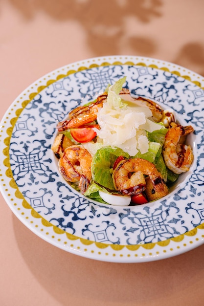 Gourmet grilled shrimp caesar salad on decorative plate