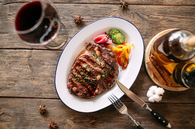 Gourmet grilled steak with a glass of red wine