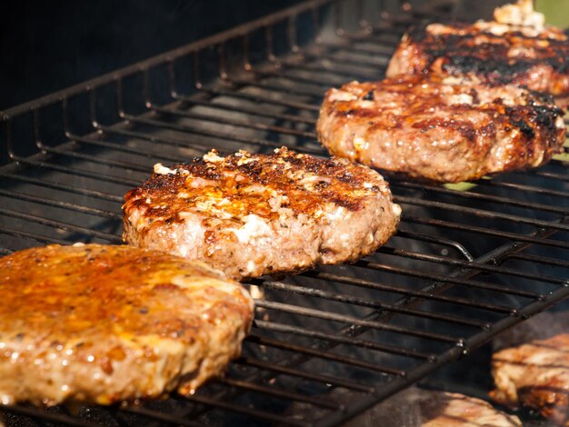 Gourmet hamburger parries on the grill.