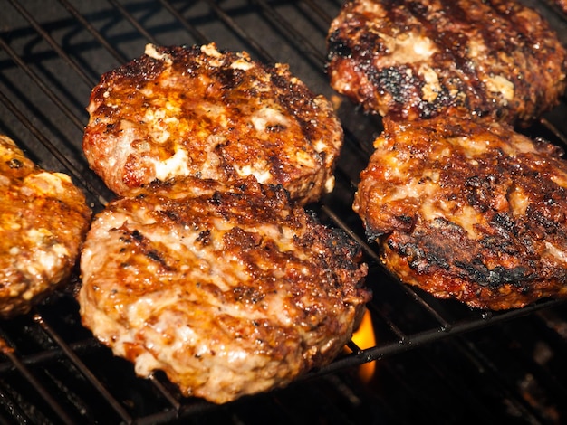 Gourmet hamburger parries on the grill.