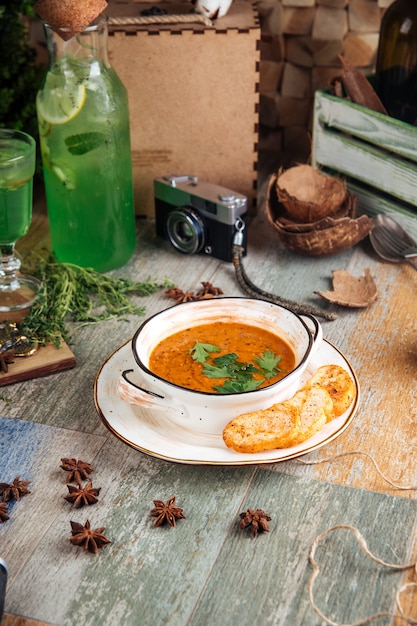 Gourmet lentil soup with croutons and lemon