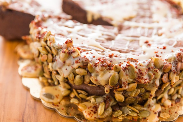 Gourmet Maya Spice torte sliced on a wooden cutting board.