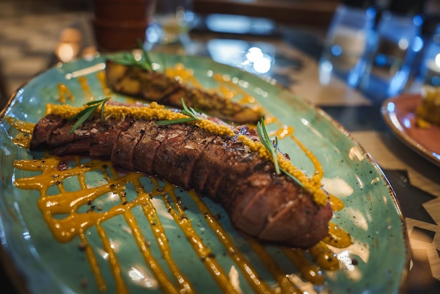 gourmet meat dish on turquoise plate in tarifa restaurant setting