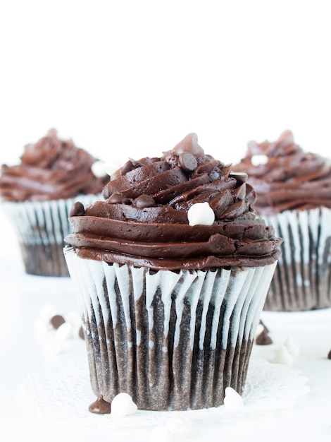 Gourmet quadruple chocolate cupcakes on white background.