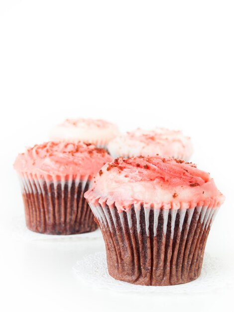 Gourmet red welveet cupcake on white background.