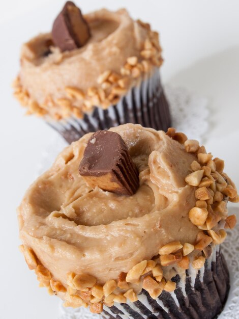 Gourmet Reese's peanut butter cups cupcake on white backround.