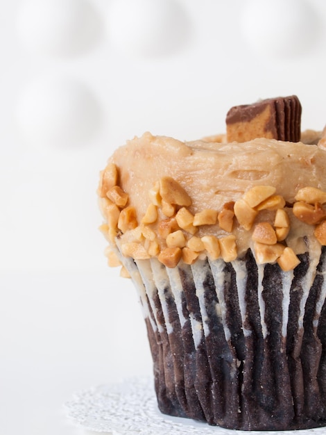 Gourmet Reese's peanut butter cups cupcake on white backround.