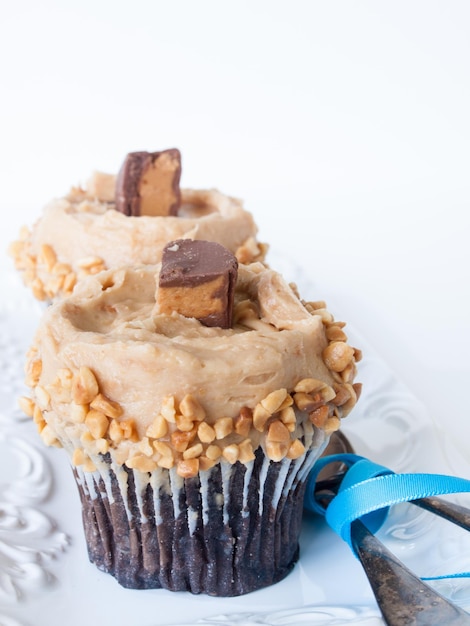 Gourmet Reese's peanut butter cups cupcake on white backround.