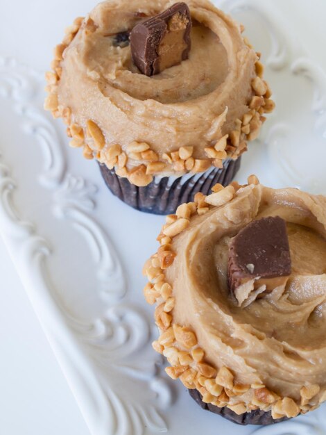 Gourmet Reese's peanut butter cups cupcake on white backround.