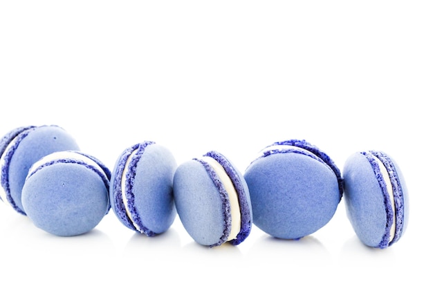 Gourmet small colorful French macarons with blueberry flavor.