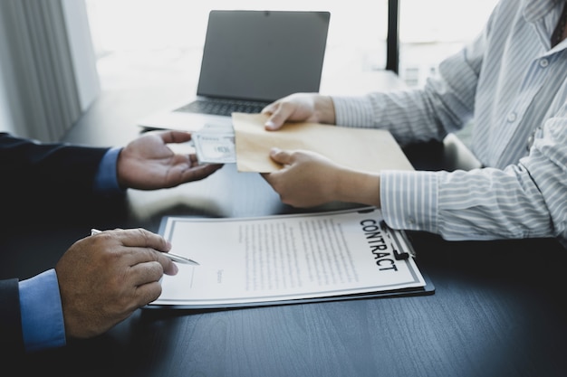 Government officials hand sign the contract and receiving bribe money from businessman