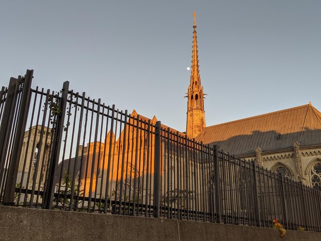 Grace cathedral on nob hill surrounded by an iron fence at sunset