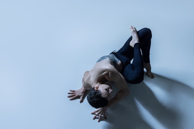 Graceful classic ballet dancer isolated on black studio background.