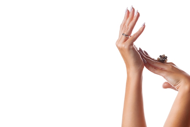 Photo graceful female hands with jewelry on a white isolated