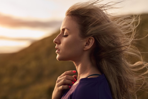 Graceful woman on windy day in nature